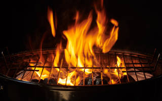 grill-background-barbecue-fire-grill-close-up-isolated-black-background